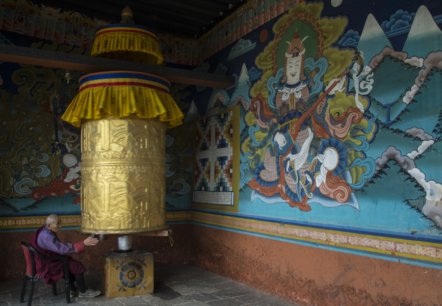Man spinning prayer wheel at Pumakha Dzong, Bhutan